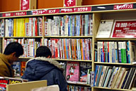 二輪コーナーの一部にあるメーカー別書籍の書架。入り口に近いところ（左手）にレース関連書とDVDをまとめている。
